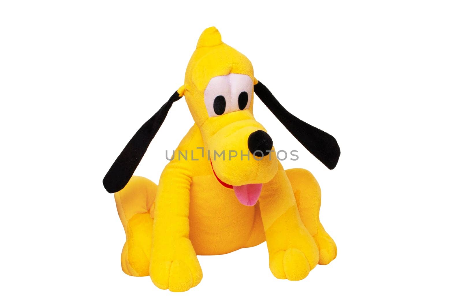 Plush toy dog isolated. Childrens toy stuffed animals. Close up of a playful yellow funny cute sitting toy plush toy dog on white background. Kids playing.