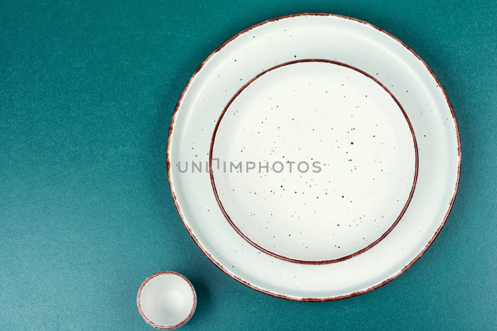 Empty ceramic plates on the kitchen table. Card or menu template. Tableware, crockery. Copy space.