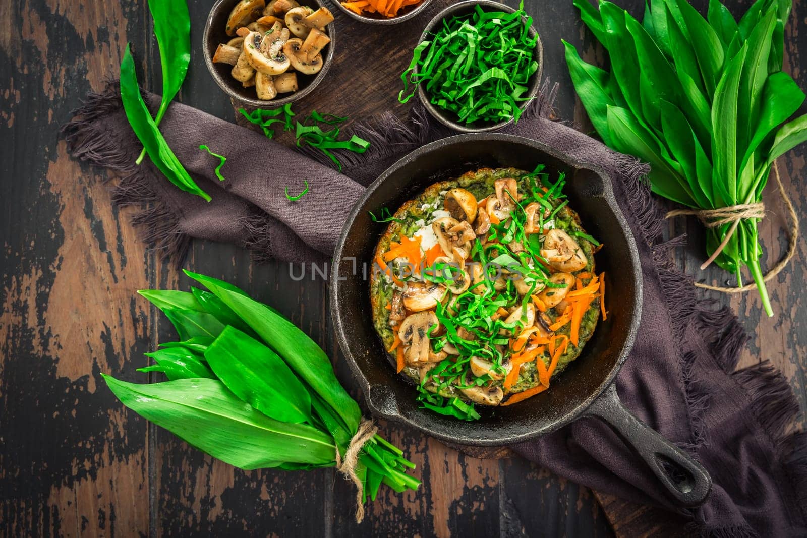 Vegetarian Quiche or oven baked pancake with ramson, carrots and mushrooms.