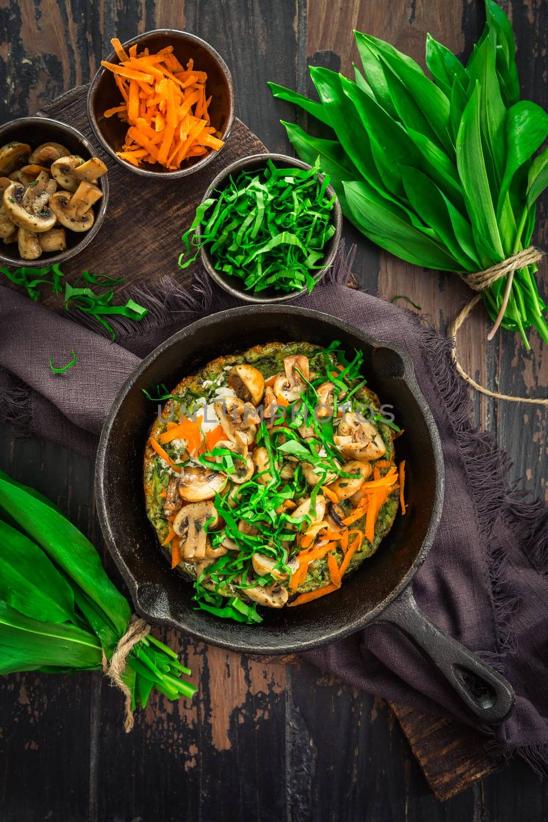 Vegetarian Quiche or oven baked pancake with ramson, carrots and mushrooms.
