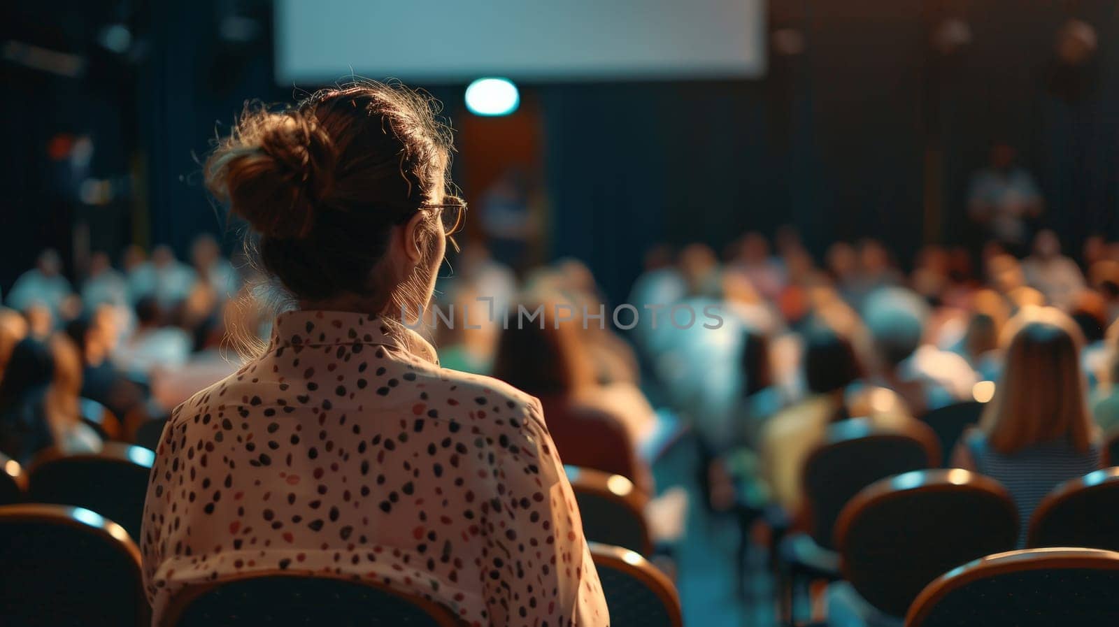Capture the dynamic atmosphere of a business conference as the speaker delivers an engaging talk while the audience listens attentively. This photo encapsulates the essence of knowledge exchange and professional networking in a conference hall setting.