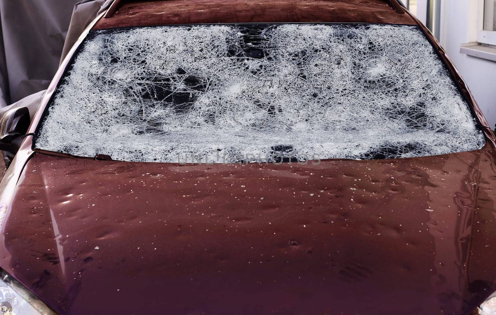 Hail damage to a car. Large hailstones have completely destroyed a car