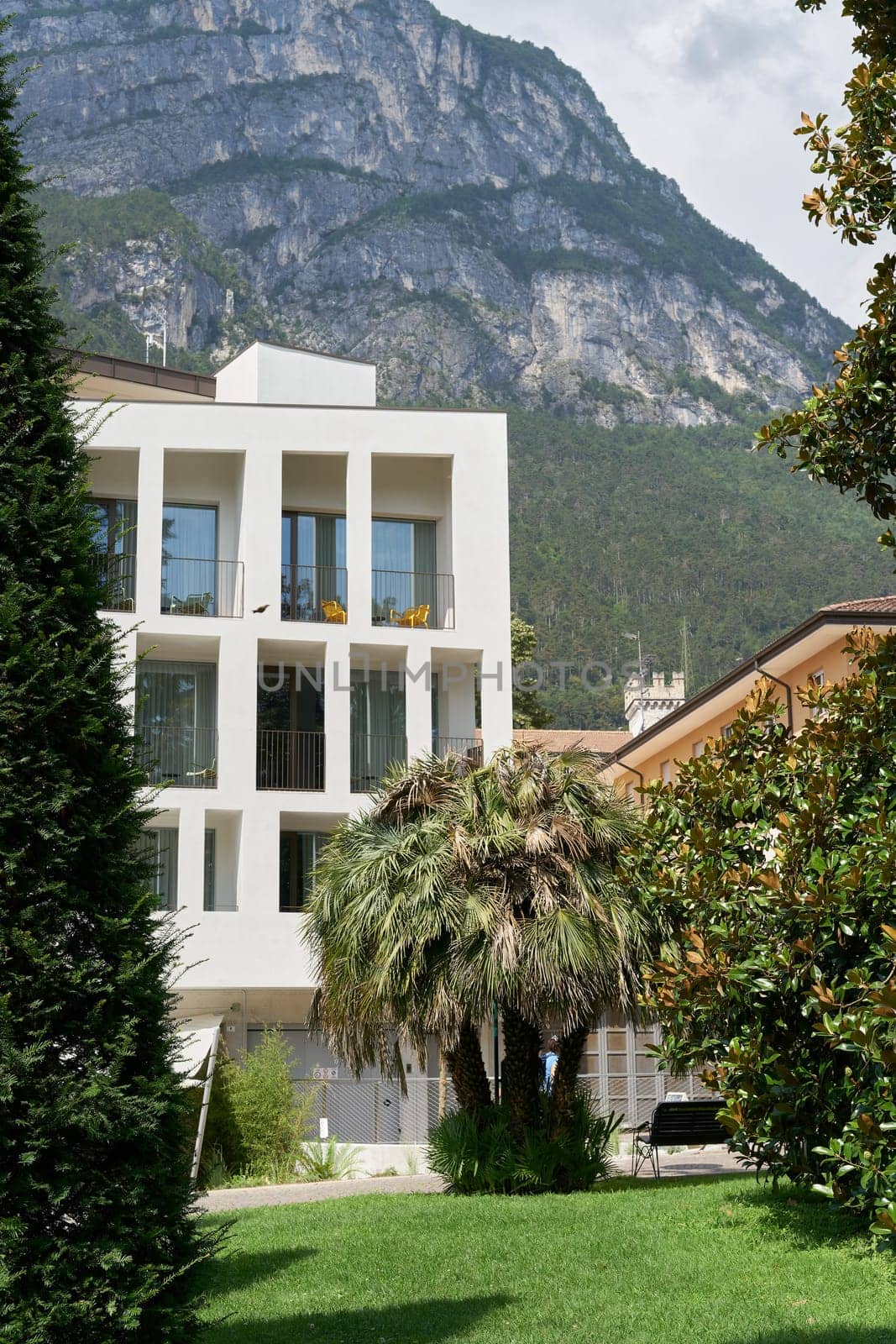 Modern accommodation for tourists in the popular historic old town of Riva del Garda in Italy as seen from the Giardini Giuseppe Verdi