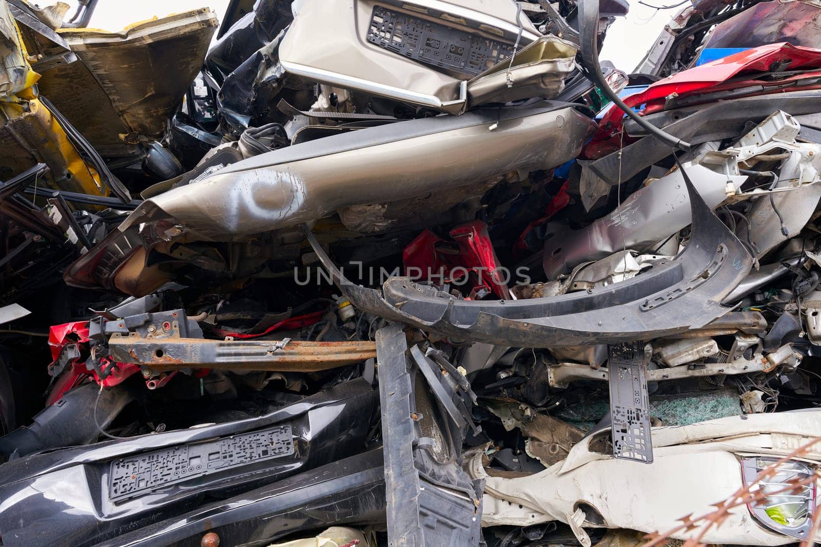 Cars in a scrap yard of a car recycling company in an industrial area in Magdeburg in Germany