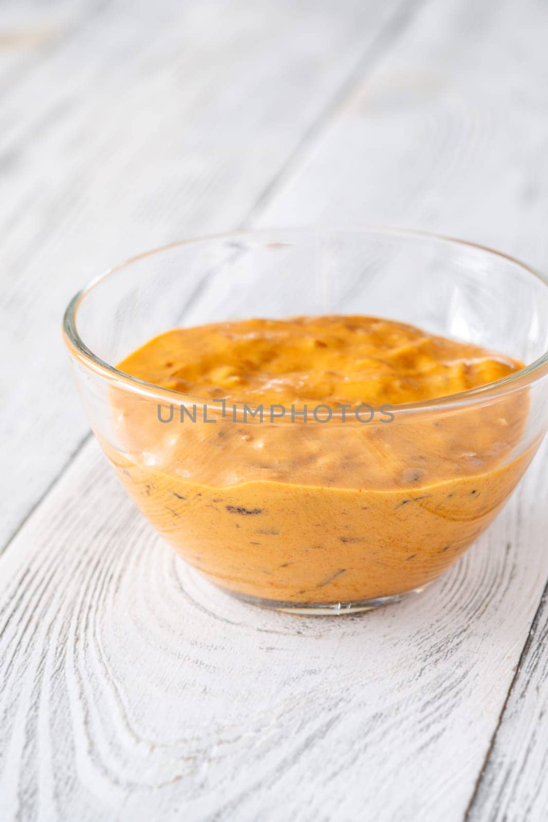 Glass bowl of burger sauce on the wooden table