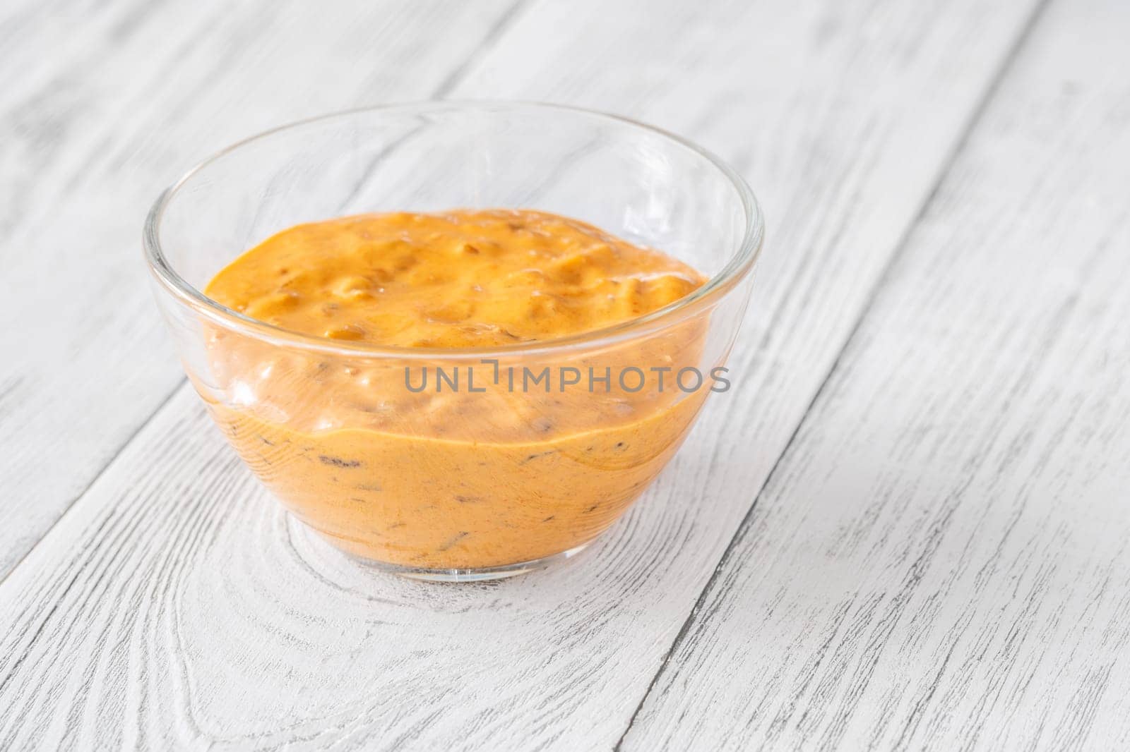 Glass bowl of burger sauce on the wooden table