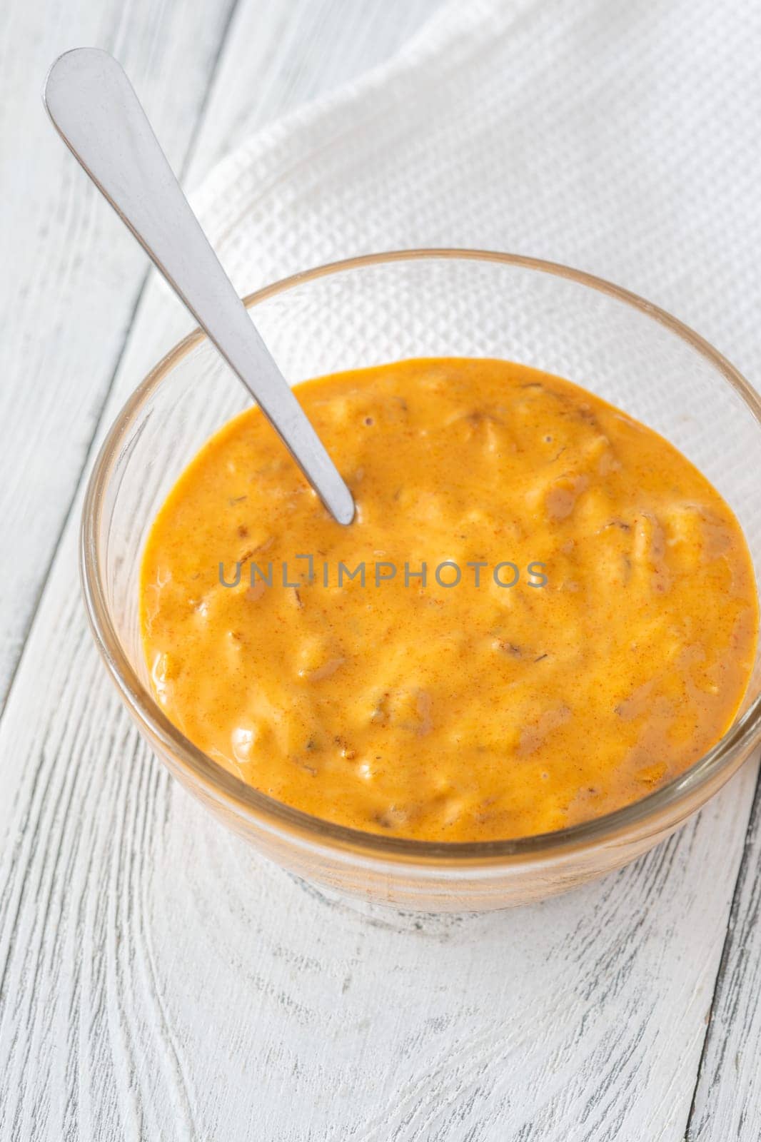 Glass bowl of burger sauce on the wooden table