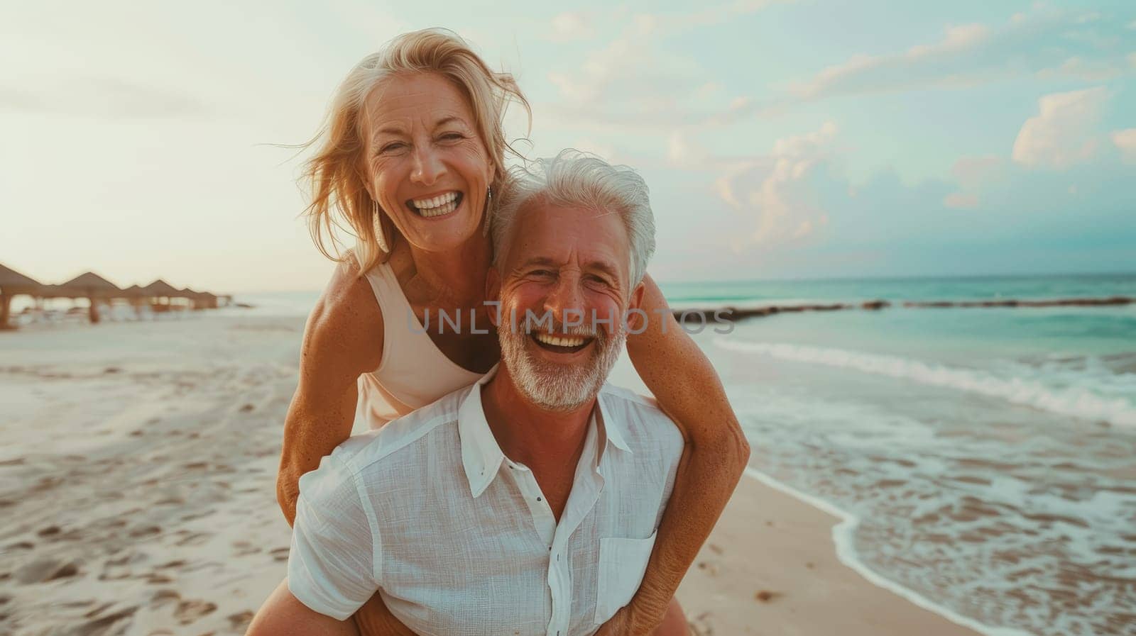 Experience the boundless happiness of a mature senior couple enjoying a carefree moment on the beach, as they share laughter and love while piggybacking under the radiant sun.