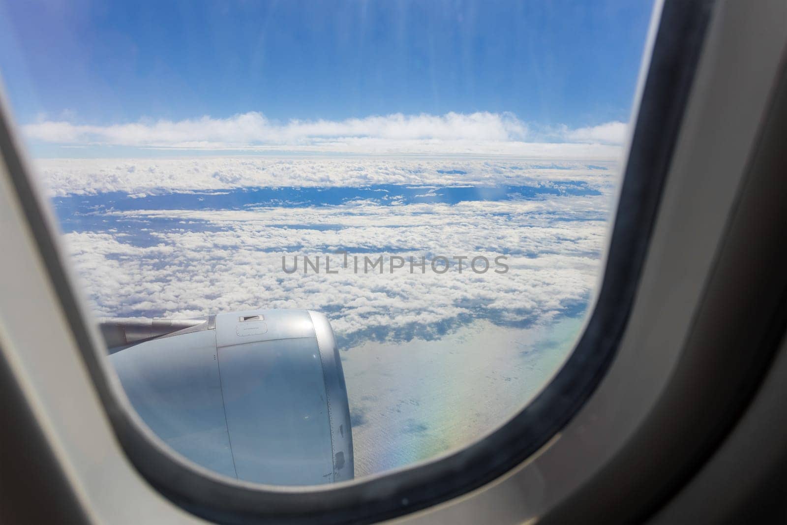 Clouds and sky as seen through window of an aircraft