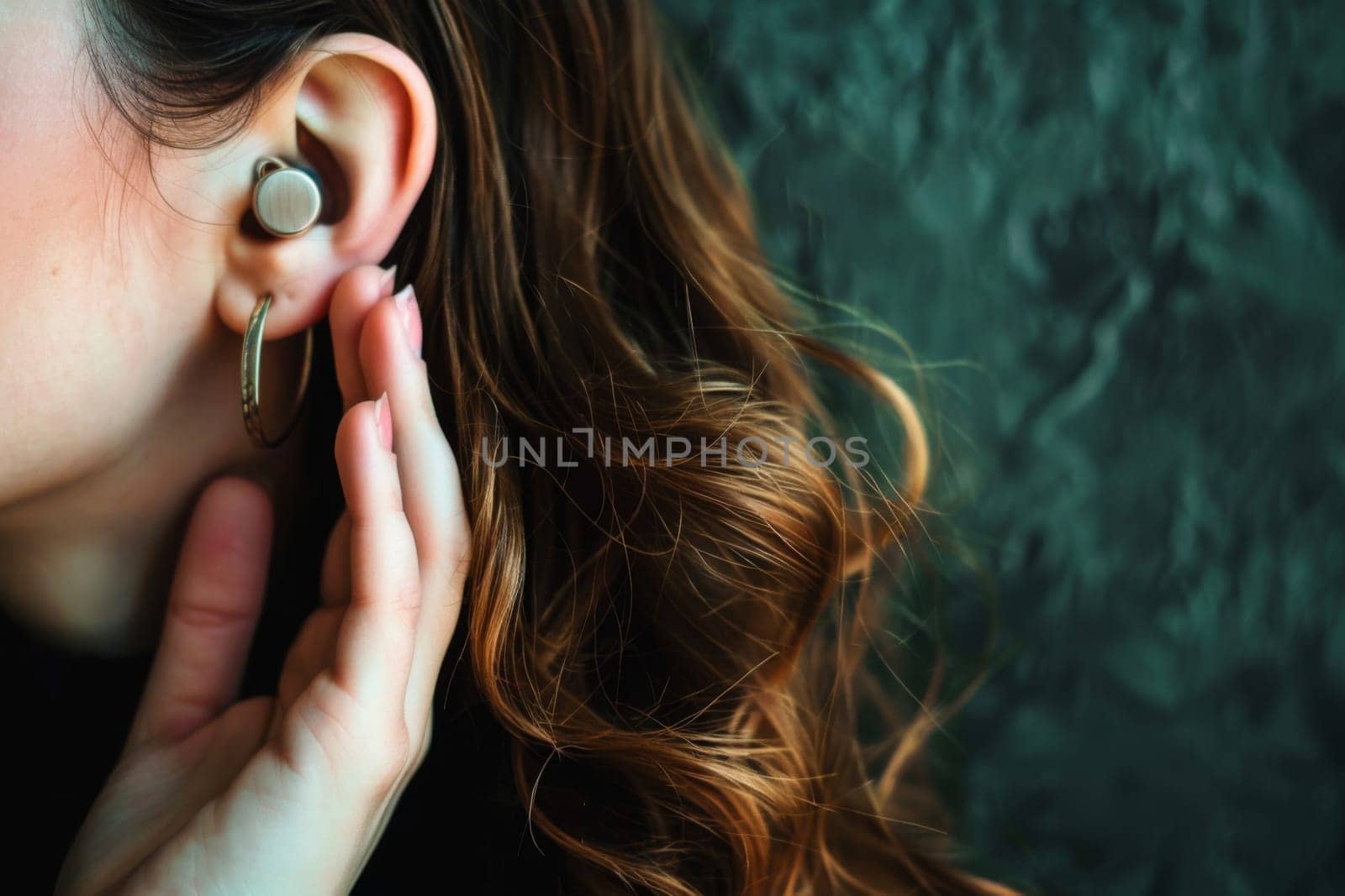 A female individual is featured in the picture, wearing a set of ear piercings. The womans earlobes are adorned with small pieces of jewelry, enhancing her appearance.