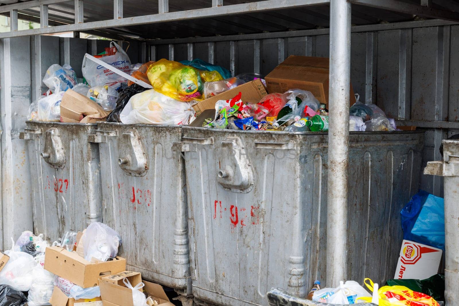 overfilled public trash bins at summer day in Bishkek, Kyrgyzstan - May 24, 2023