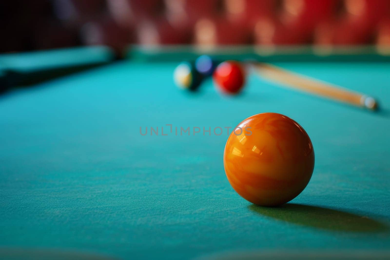 A pool table is shown with a single pool ball placed on its surface, ready for a game to begin. The green felt of the table contrasts with the colorful ball.