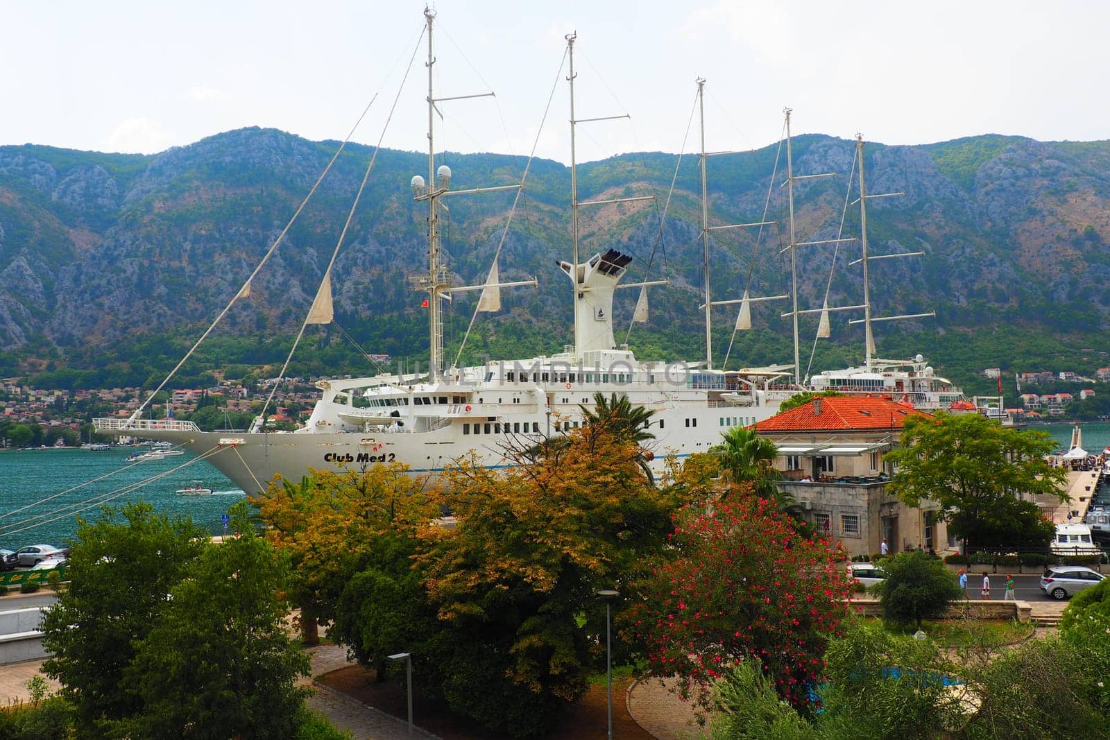 Kotor, Montenegro, 08.11.22 view of Adriatic Sea from historical center of old town. Cruise ship, tourists, cars and mountains in summer evening. Tourism business in the Balkans and the Mediterranean