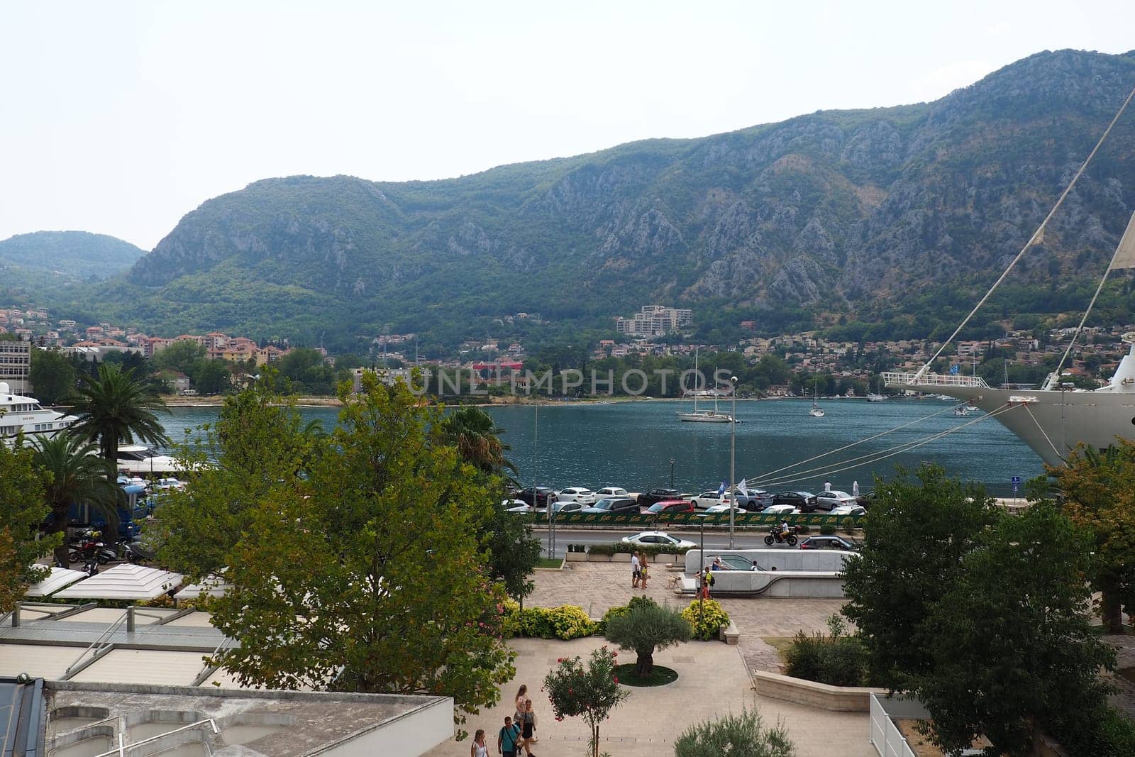 Kotor, Montenegro, 08.11.22 view of Adriatic Sea from historical center of old town. Cruise ship, tourists, cars and mountains in summer evening. Tourism business in the Balkans and the Mediterranean