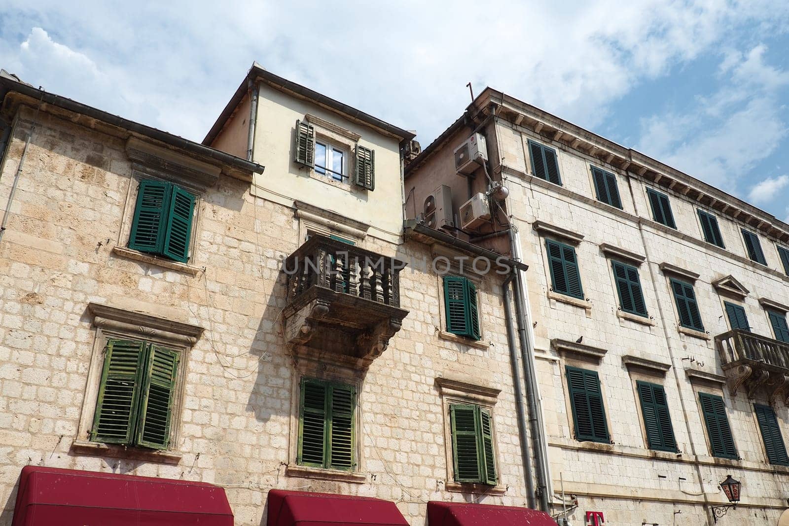 Kotor, Montenegro, 08.11.22: Trg od Oruzja, Arms Square, town square in old city. Square of the Arms. Tourists, women and men, walk along paving stones. Restaurants, souvenir shops. Excursion tourism