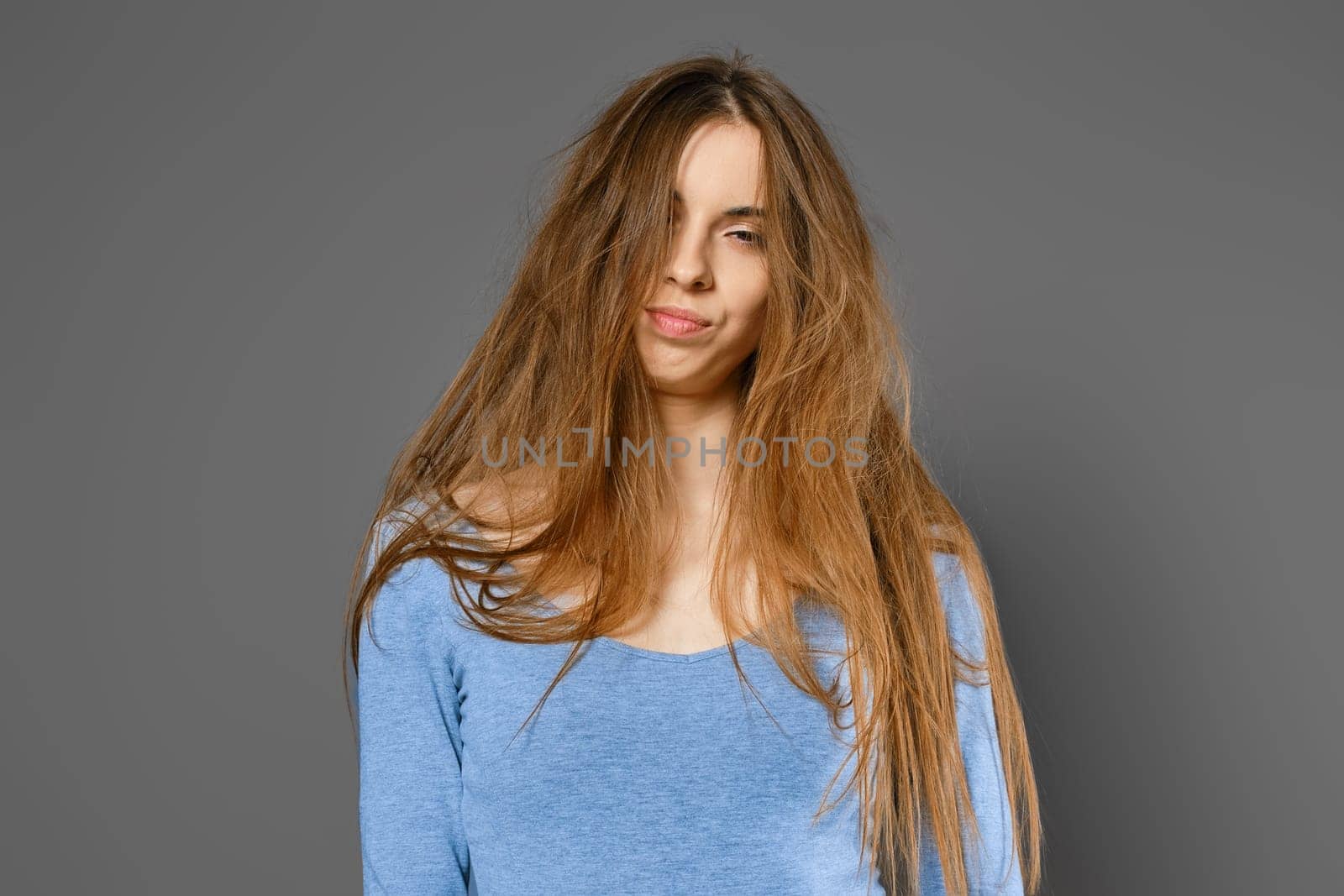 Portrait of annoyed woman with long tangled hair