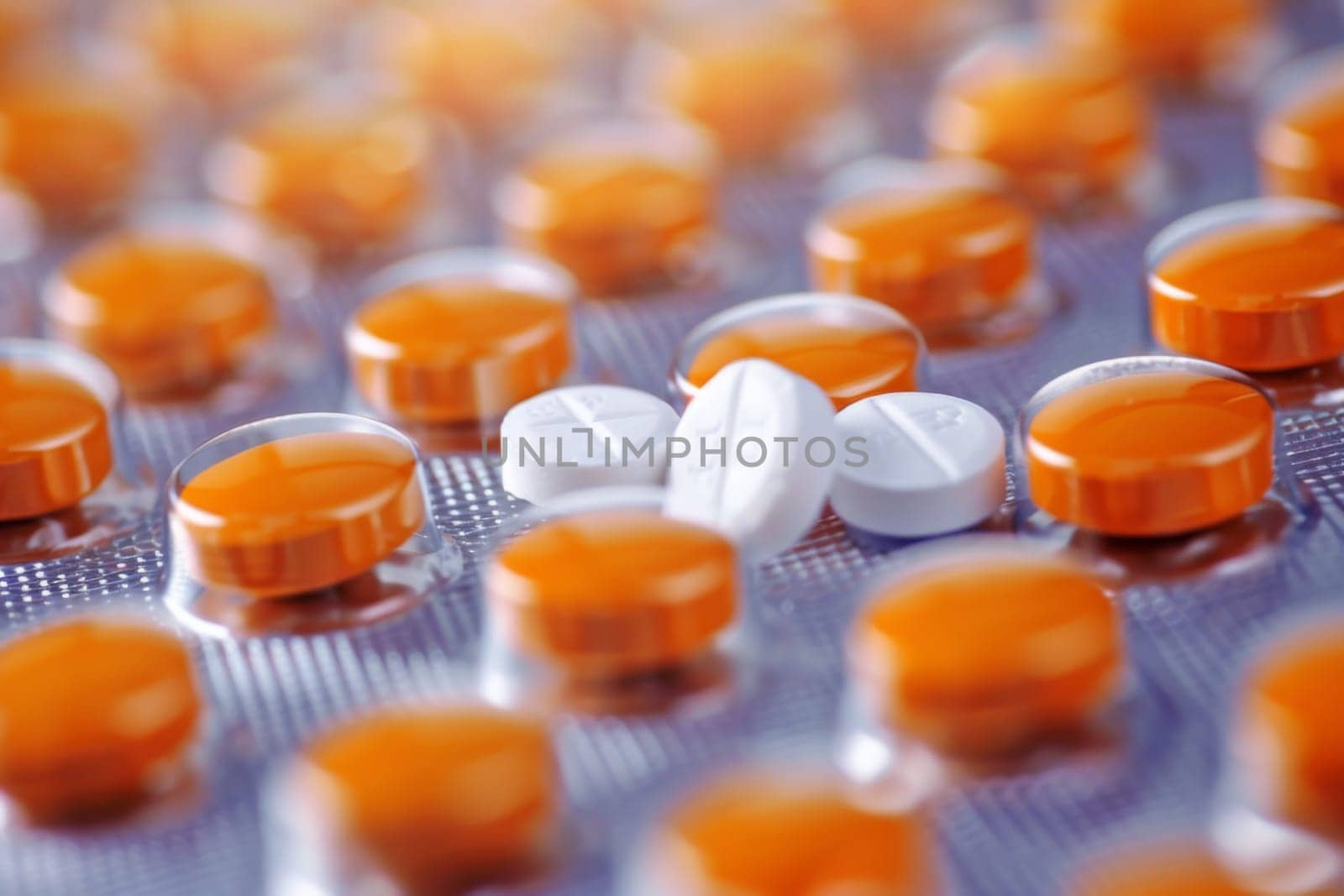 A close-up view showing a multitude of orange and white pills clustered together, creating a visually striking pattern. The pills are organized neatly, showcasing their vibrant colors and textures.