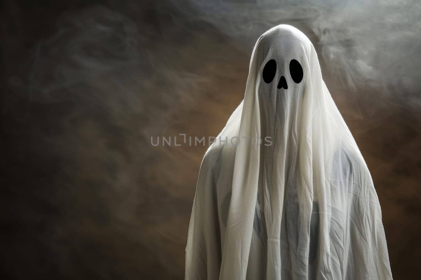 A ghost with two eyes and a long white cloak is depicted in the image. The ghost is floating, looking eerie with its white cloak billowing around it.