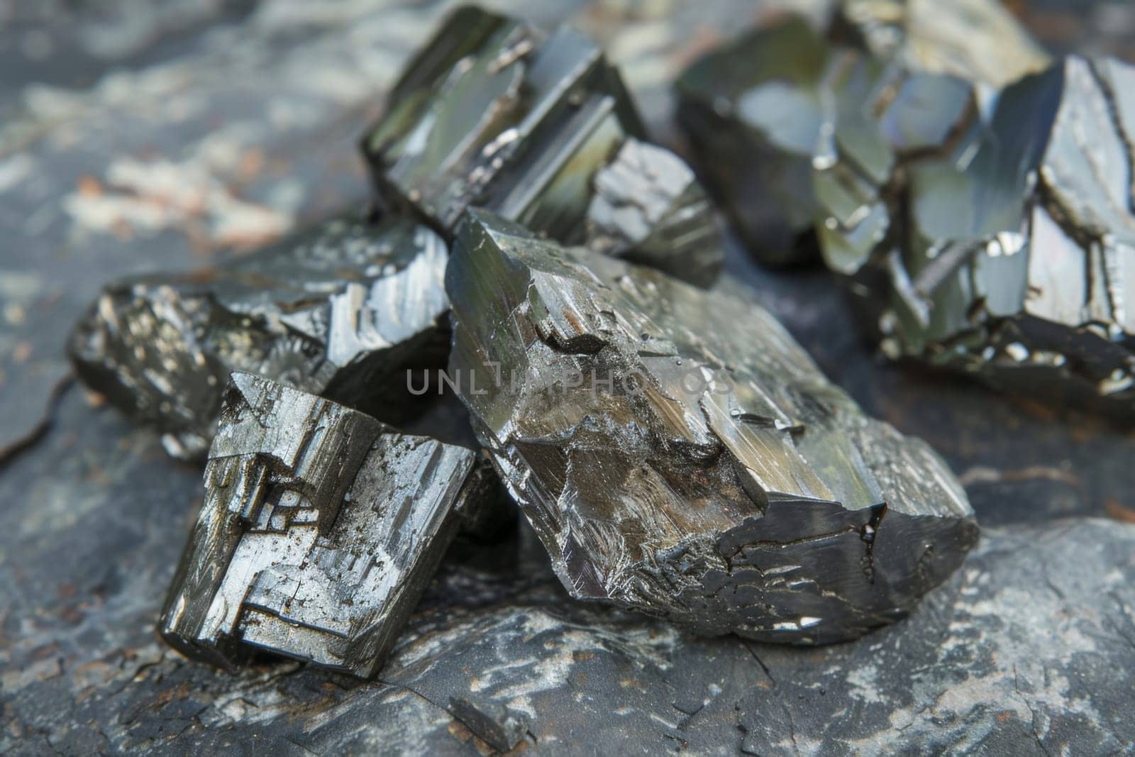 A pile of rocks of various shapes and sizes, sitting on the ground in a loose formation. The rocks appear weathered and blend naturally into the surrounding landscape.