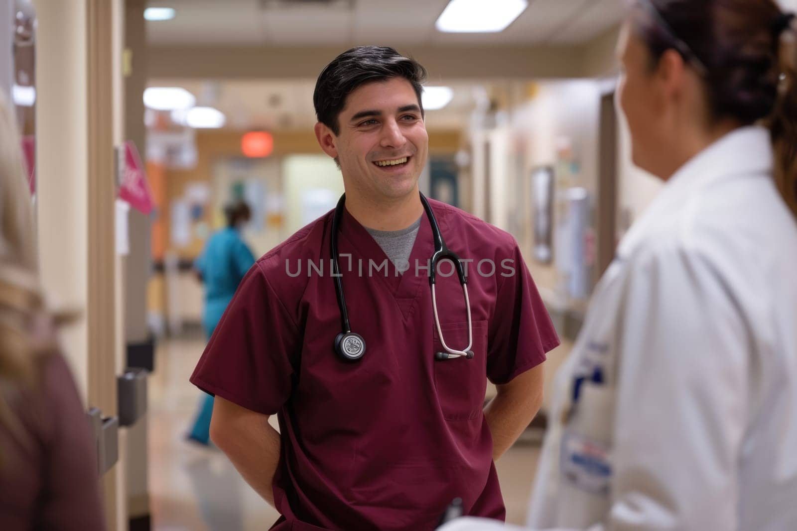 Male nurse practitioner wearing maroon scrubs and white coat talking to colleagues at work in hospital. AI Generated.