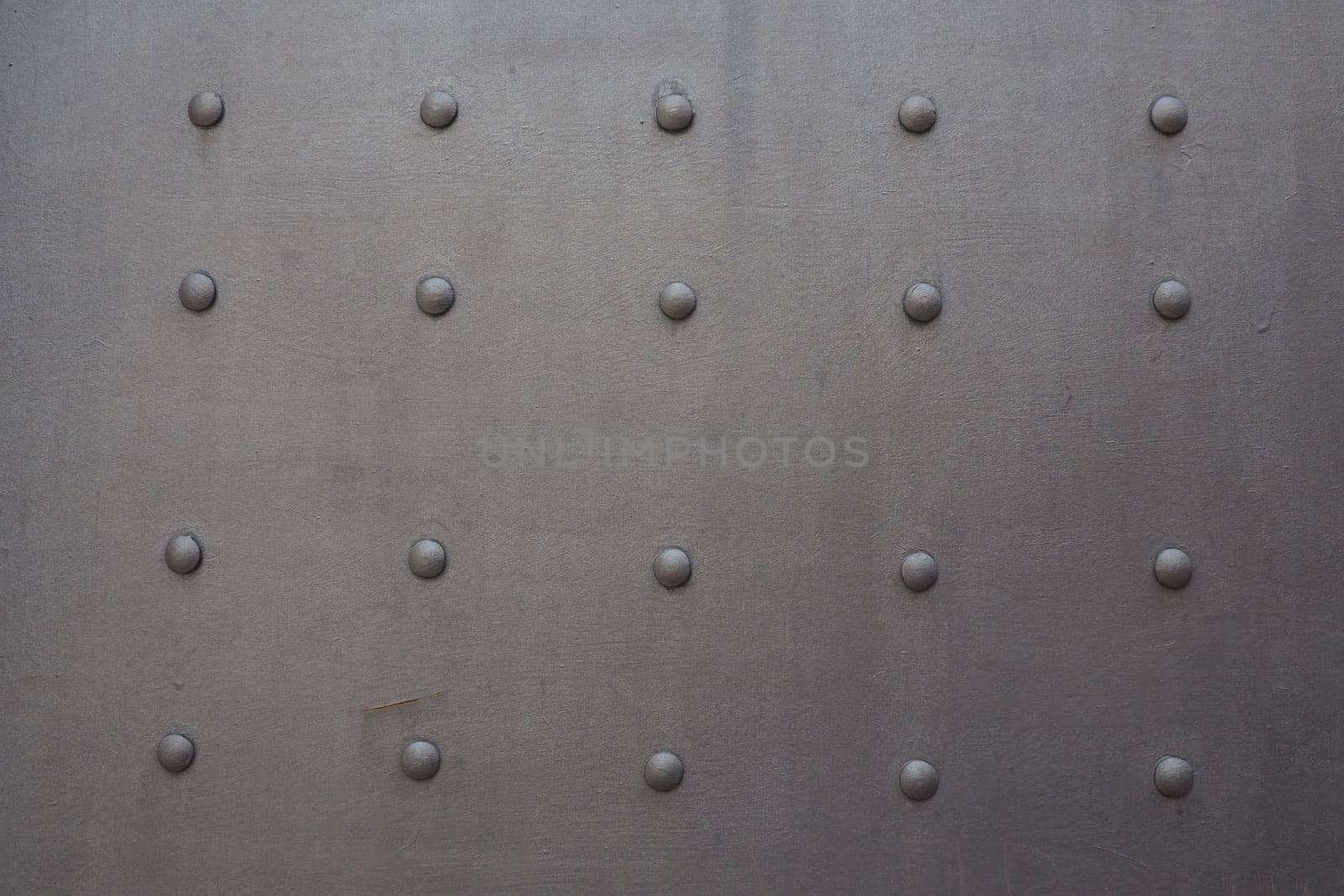 Fortress metal door with rivets. Old medieval castle in Kotor, Montenegro. Entrance to the fortress. Wrought iron door with pattern. Medieval style with rivets of steel. Beautiful stylish gothic door