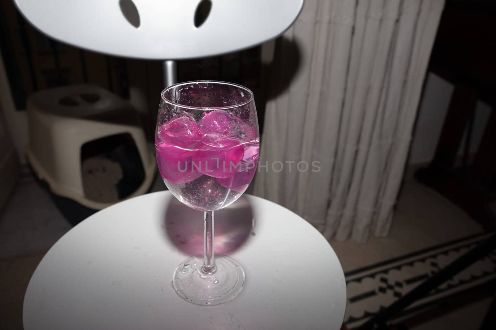 empty glass with ice cubes on white background