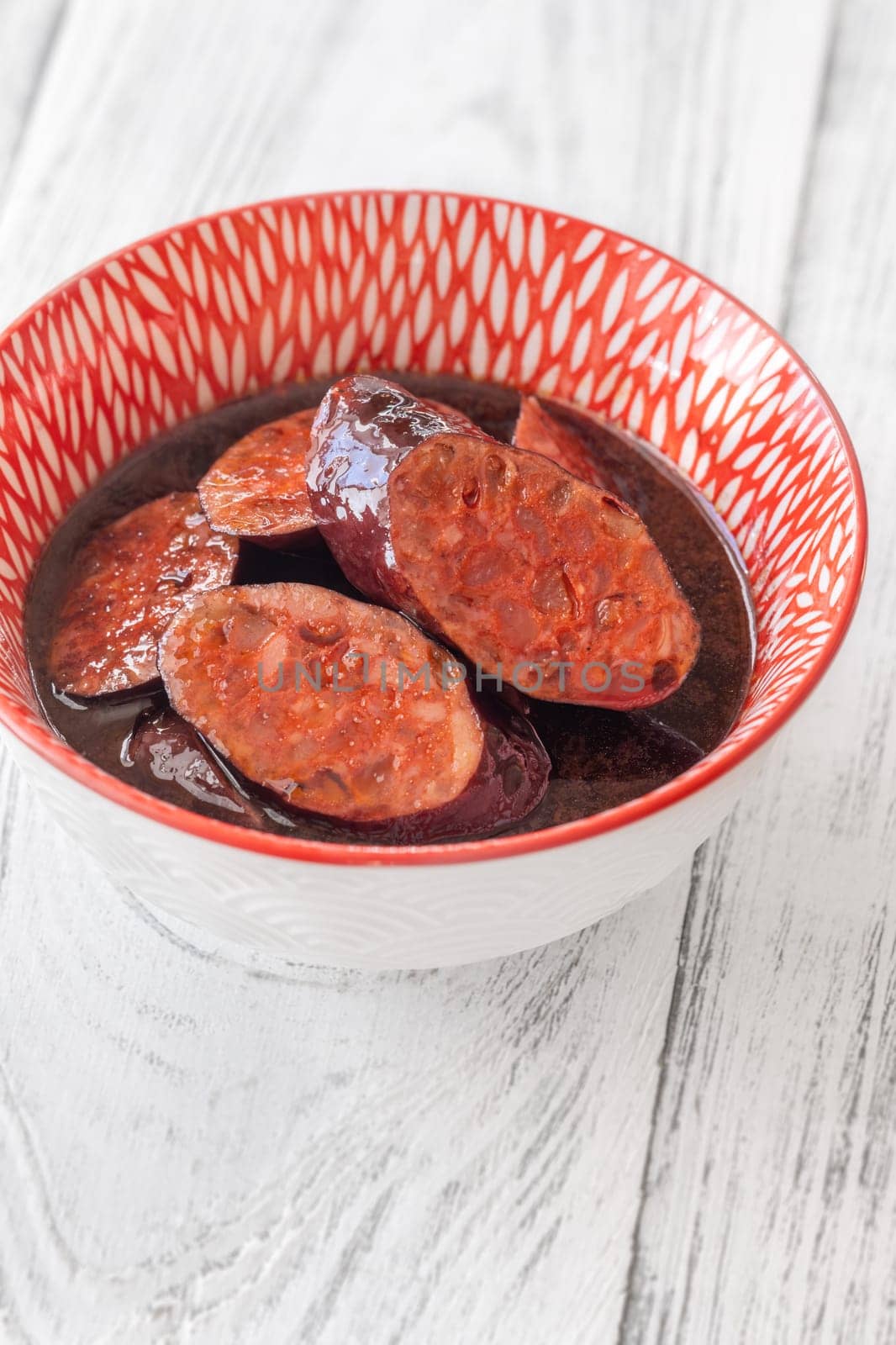 Bowl of chorizo sausage cooked in red wine
