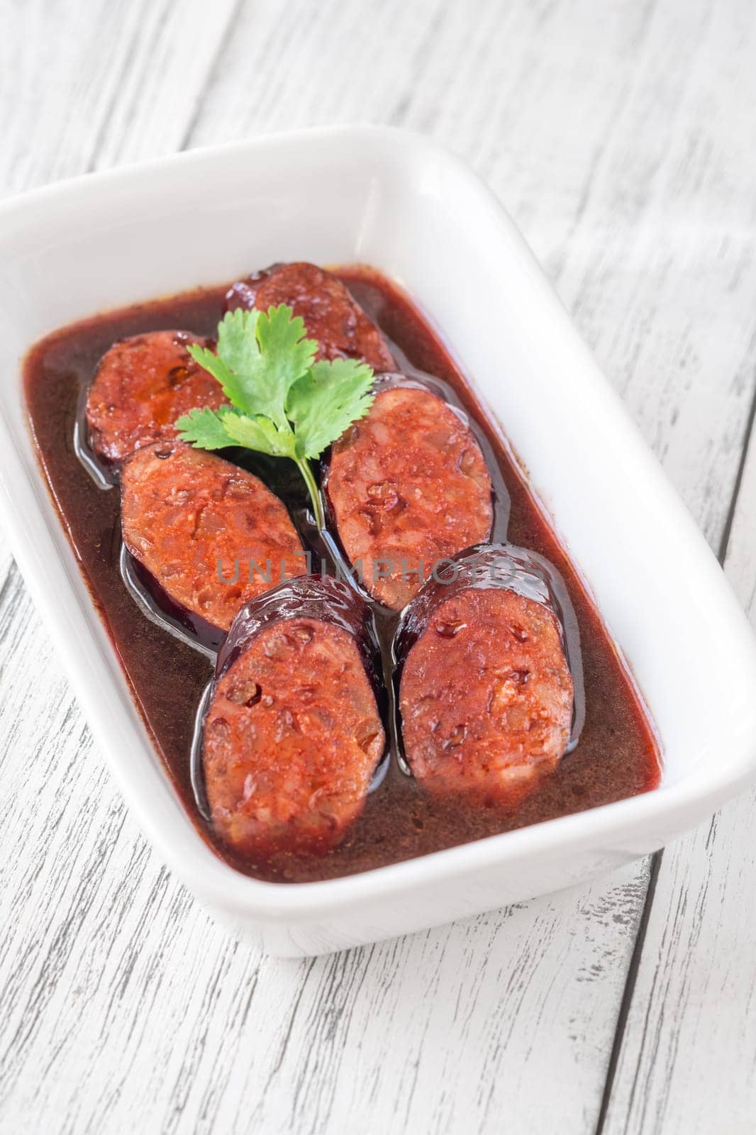 Bowl of chorizo sausage cooked in red wine