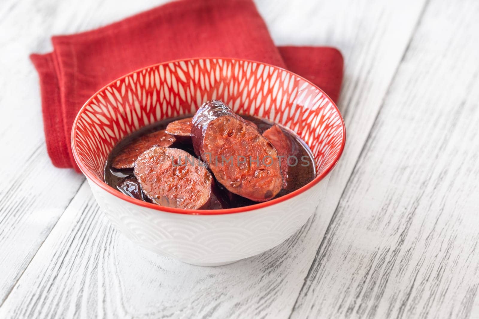 Bowl of chorizo sausage cooked in red wine