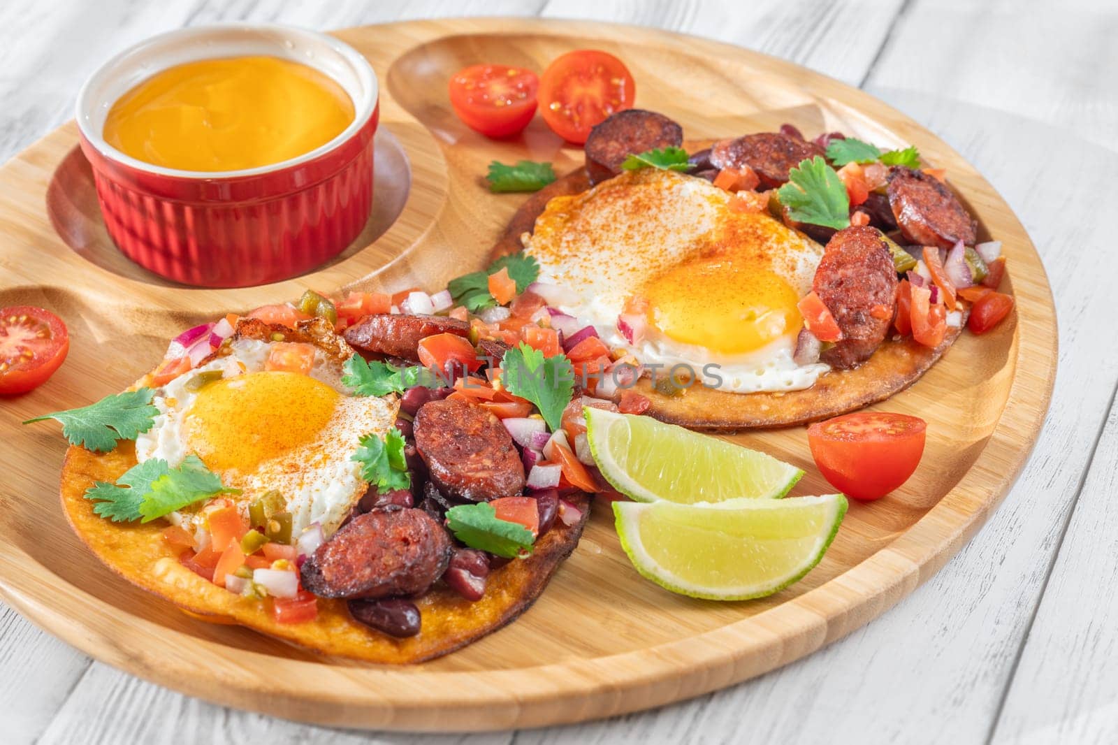 Chorizo and egg tostadas with cheddar cheese sauce