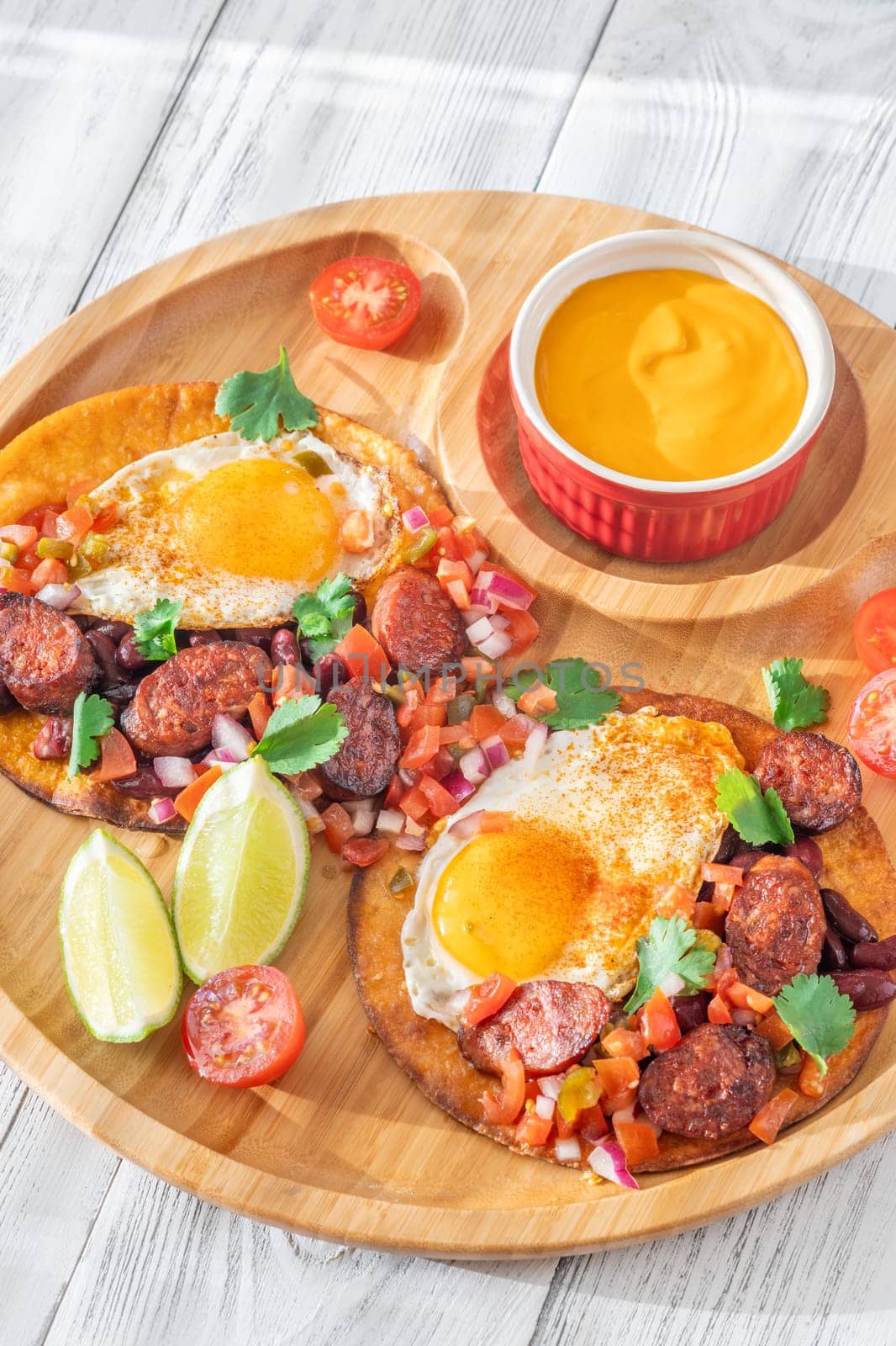 Chorizo and egg tostadas with cheddar cheese sauce