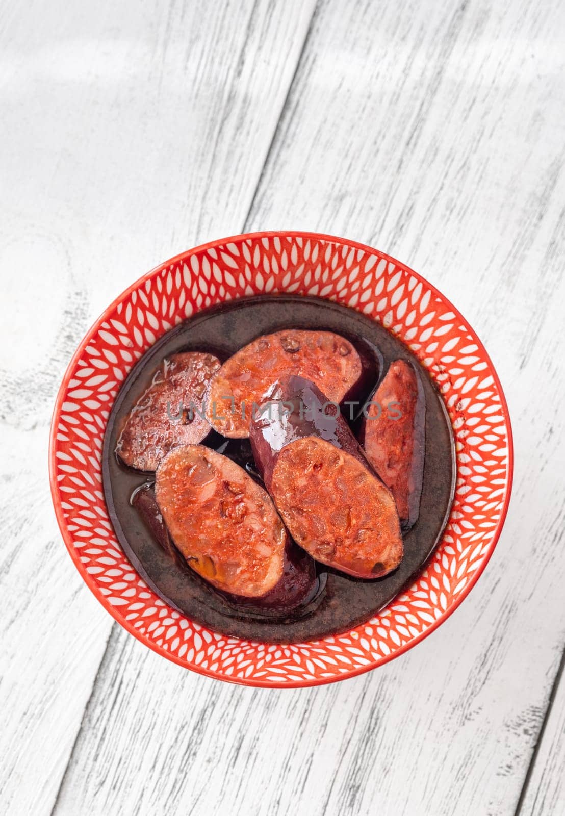 Bowl of chorizo sausage cooked in red wine
