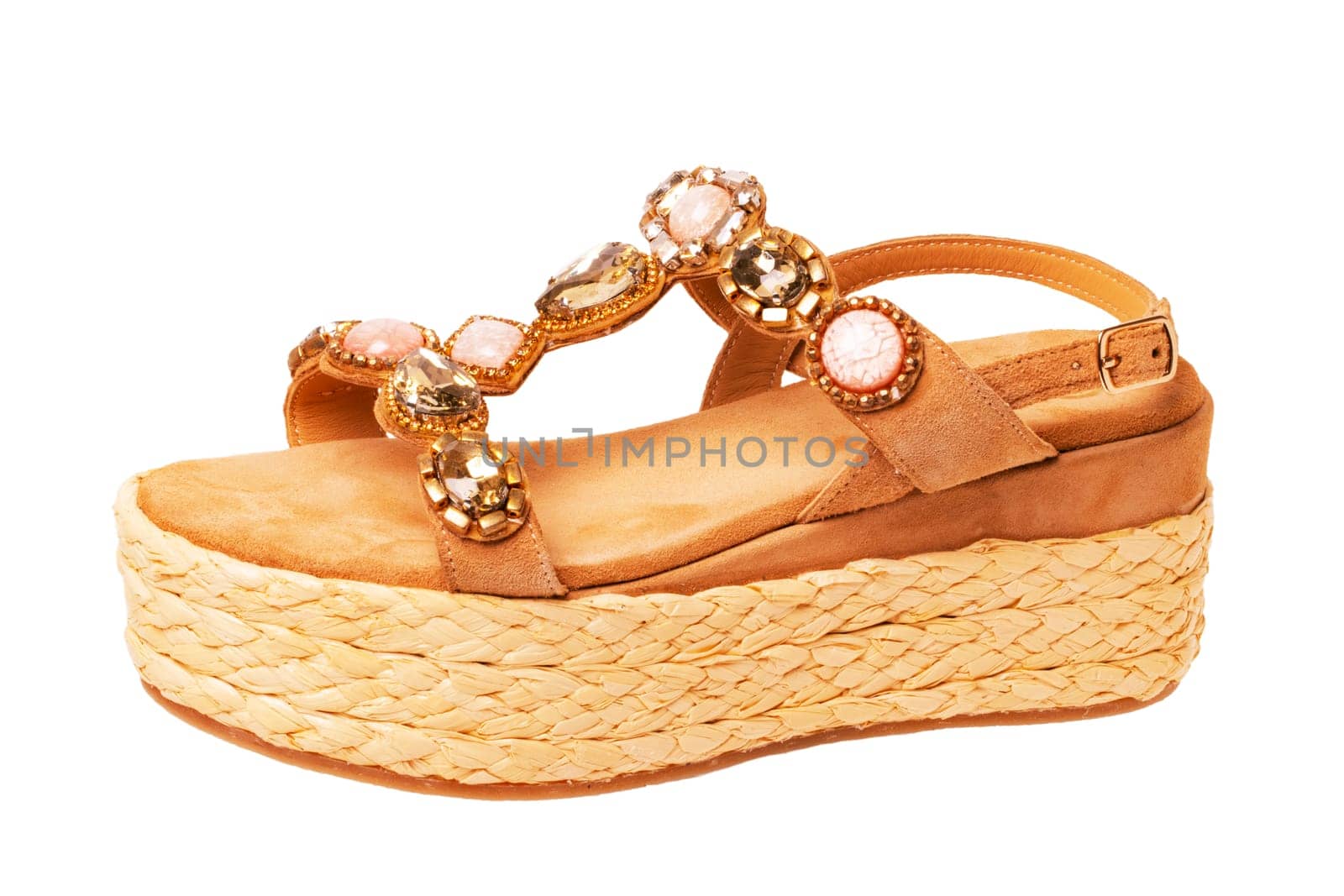 Leather shoes isolated. Close-up of a single of elegant female suede sandals with rhinestones. Isolated on white background. Macro.