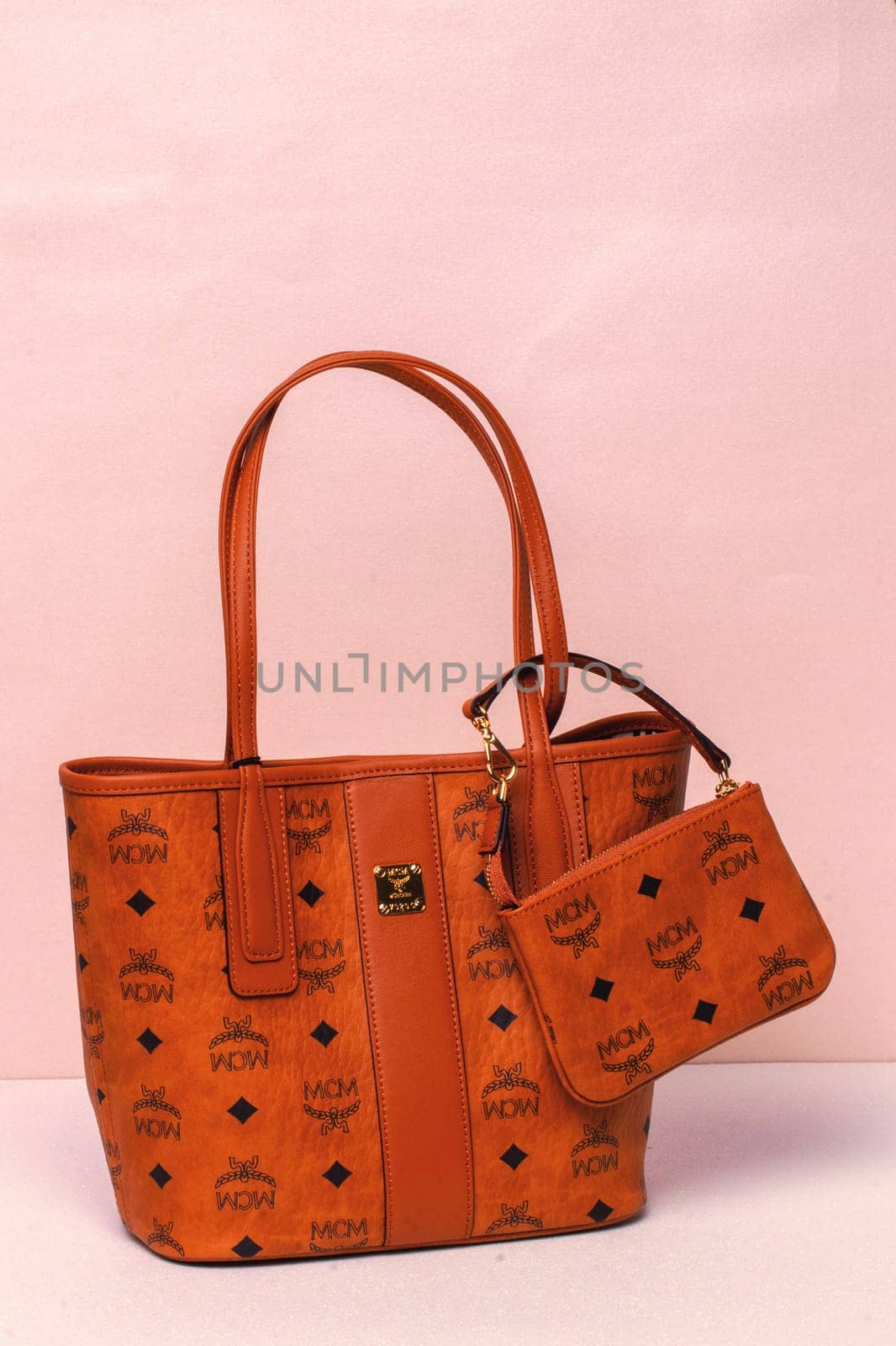 Berlin, Germany – March 29, 2024. Close-up of luxury expensive brown MCM leather handbag on a bright background.