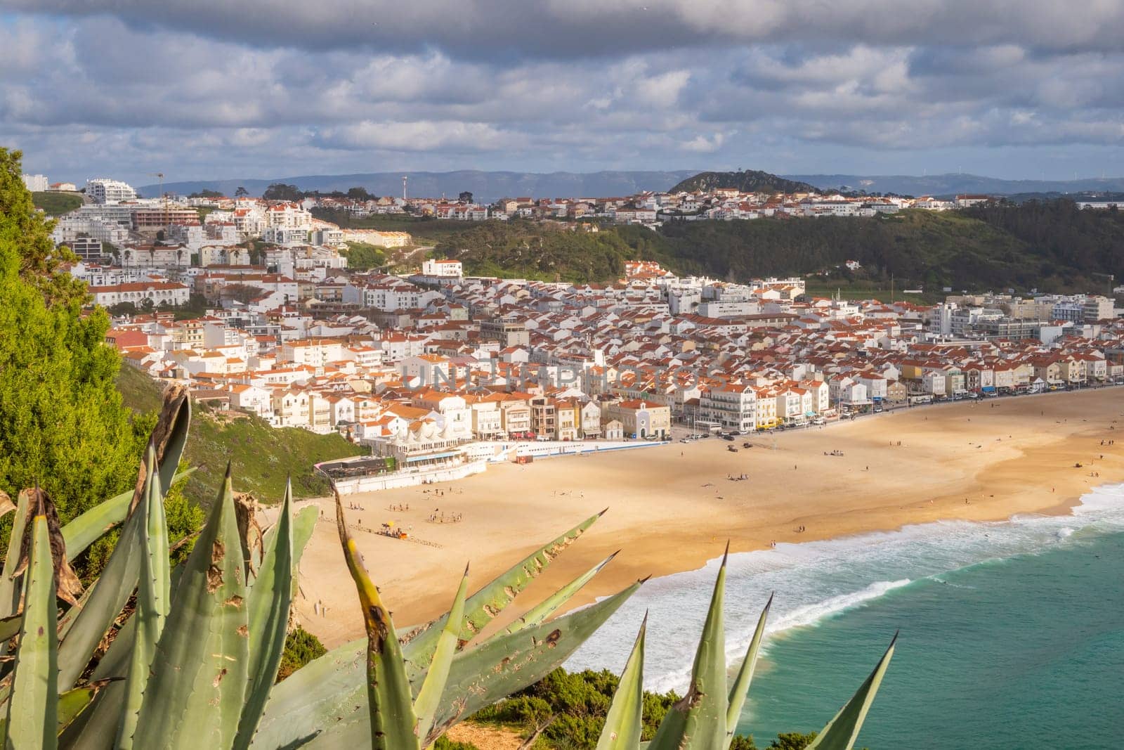 Aerial view over Nazaré town, Portugal, down to beach and Atlantic Ocean