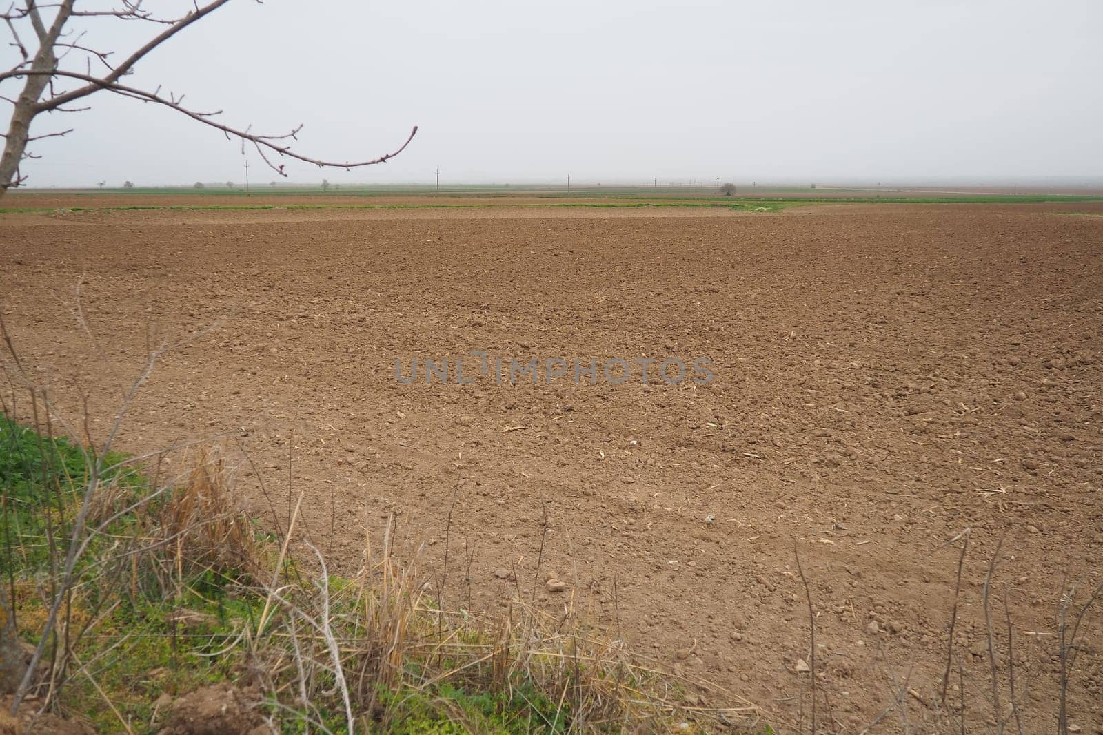 A tractor-plowed field in Chalma, Serbia. Agribusiness. Agricultural land. Fertile black soil. Row of furrows in a plowed field prepared for planting crops in the spring. Horizontal perspective view