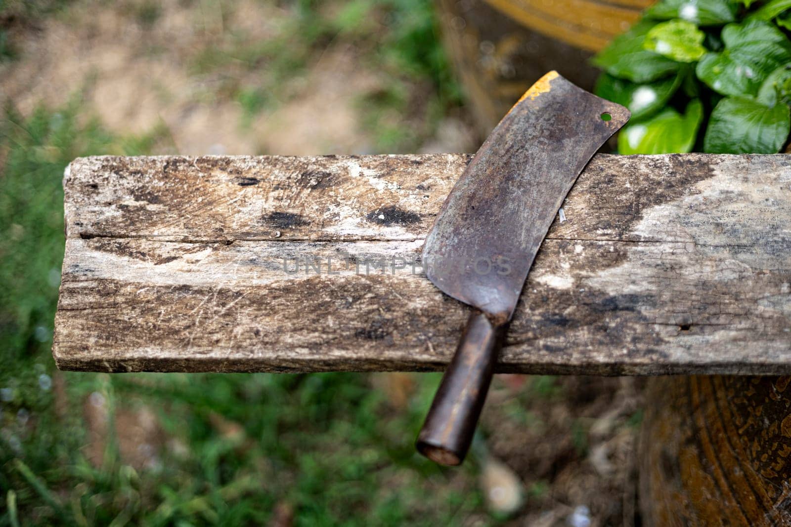 Big kitchen knife rests on a wooden board. Thai people's way of life uses knives and wooden cutting boards as cooking tools.