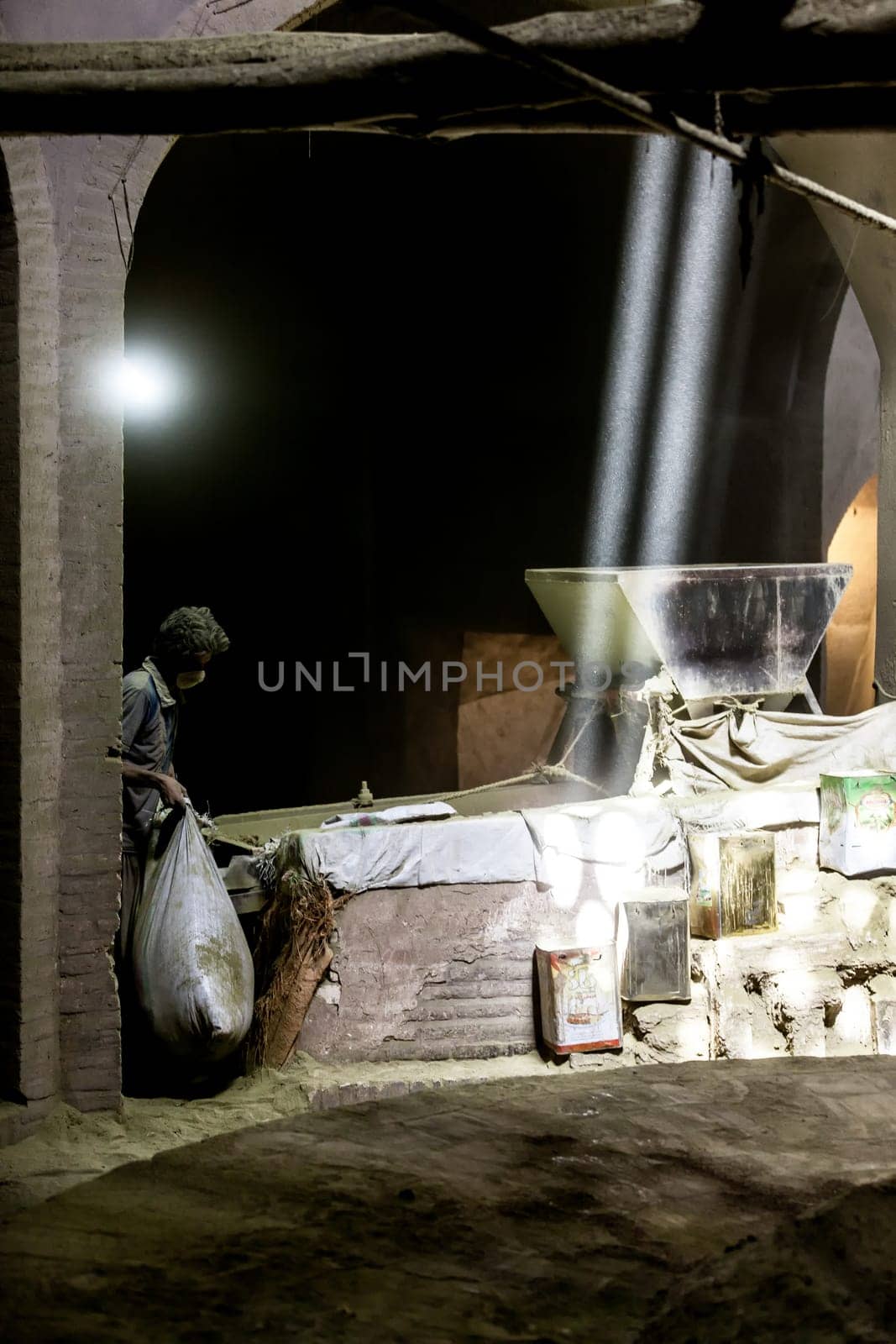 CIRCA August 2014 Teheran, Iran. Man working at the mill grain