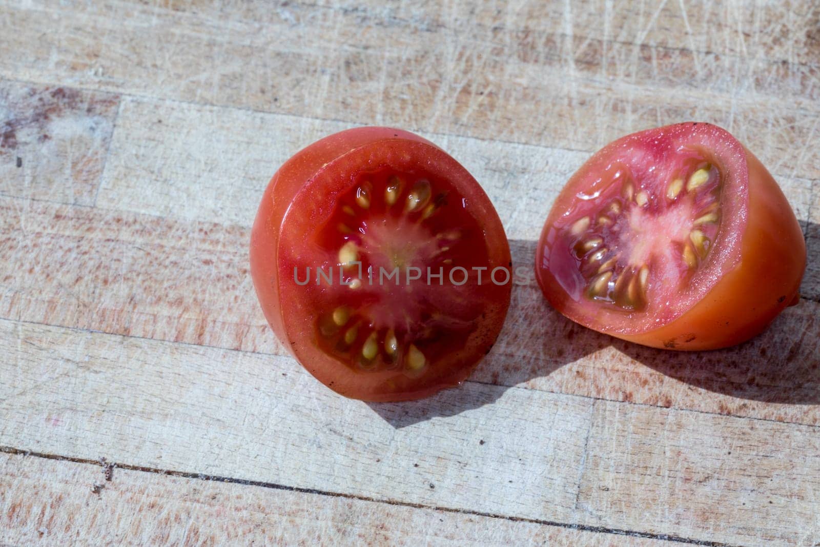 Tomato and black truffle isolated on a wooden cutting board