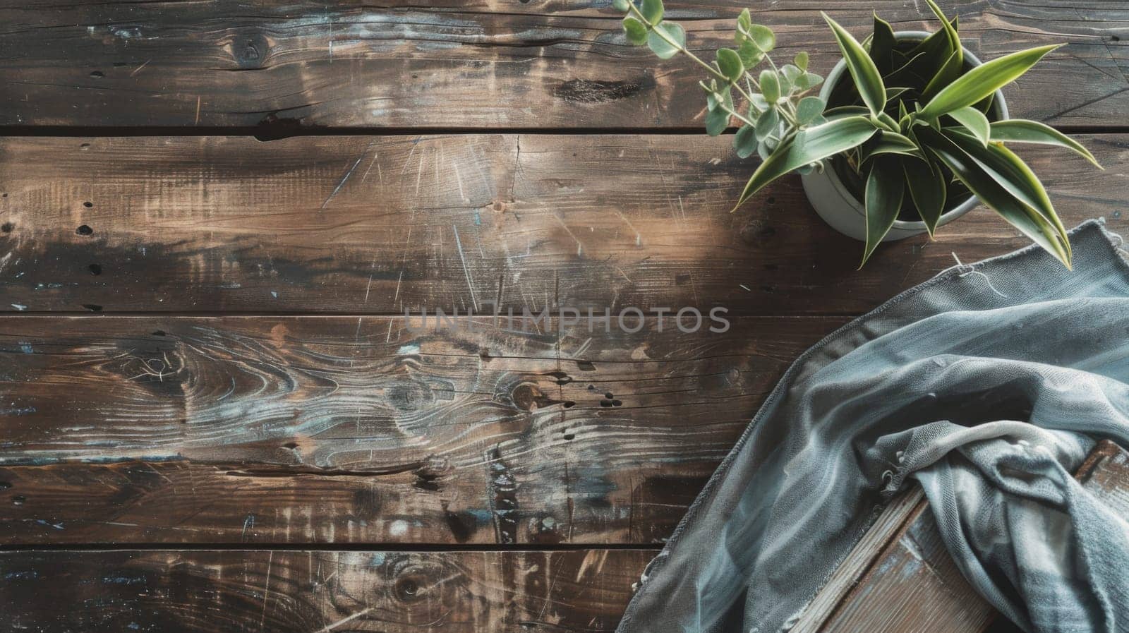 A potted plant is placed on top of a wooden table, the green leaves contrasting with the brown table surface. The plant appears healthy and well cared for, adding a touch of nature to the indoor space.