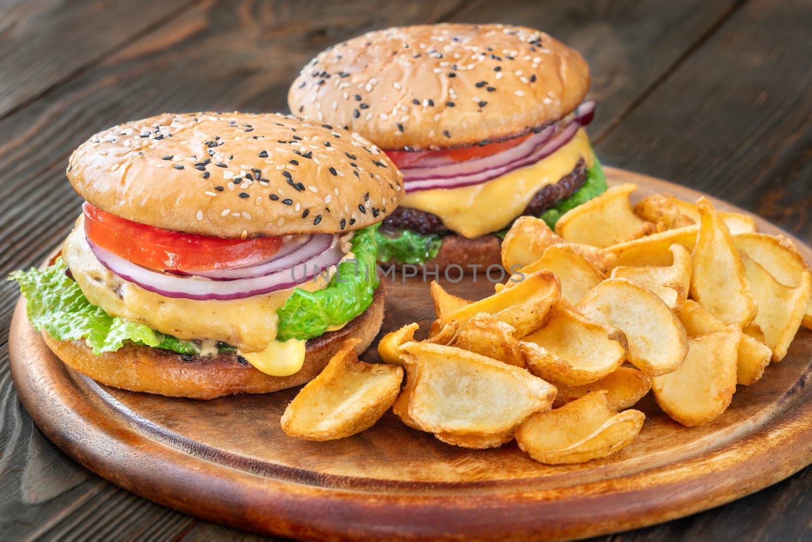 Two homemade hamburgers served with potato dippers