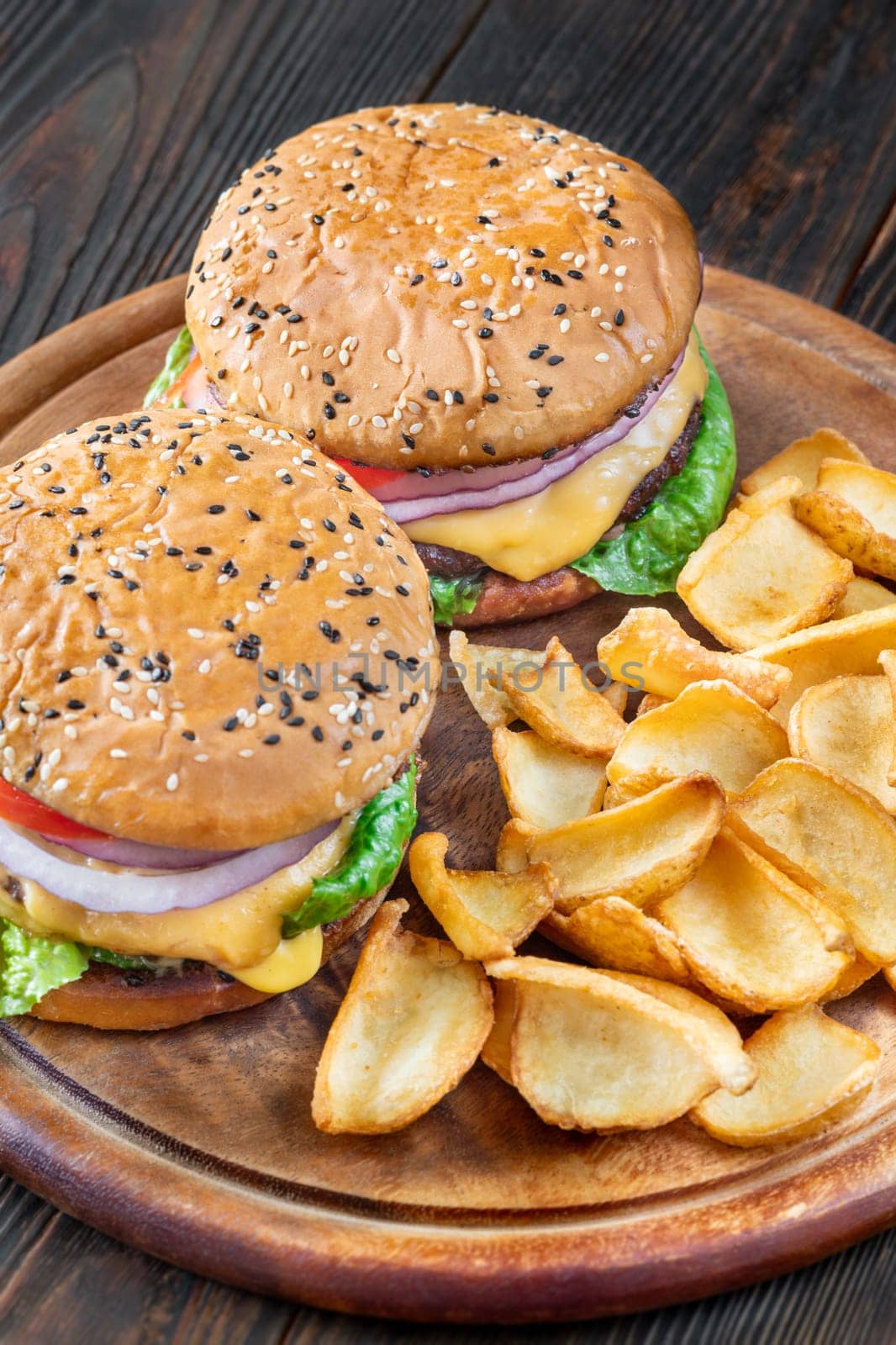 Two homemade hamburgers served with potato dippers