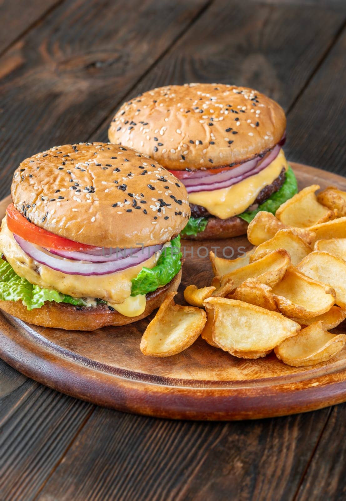Two homemade hamburgers served with potato dippers