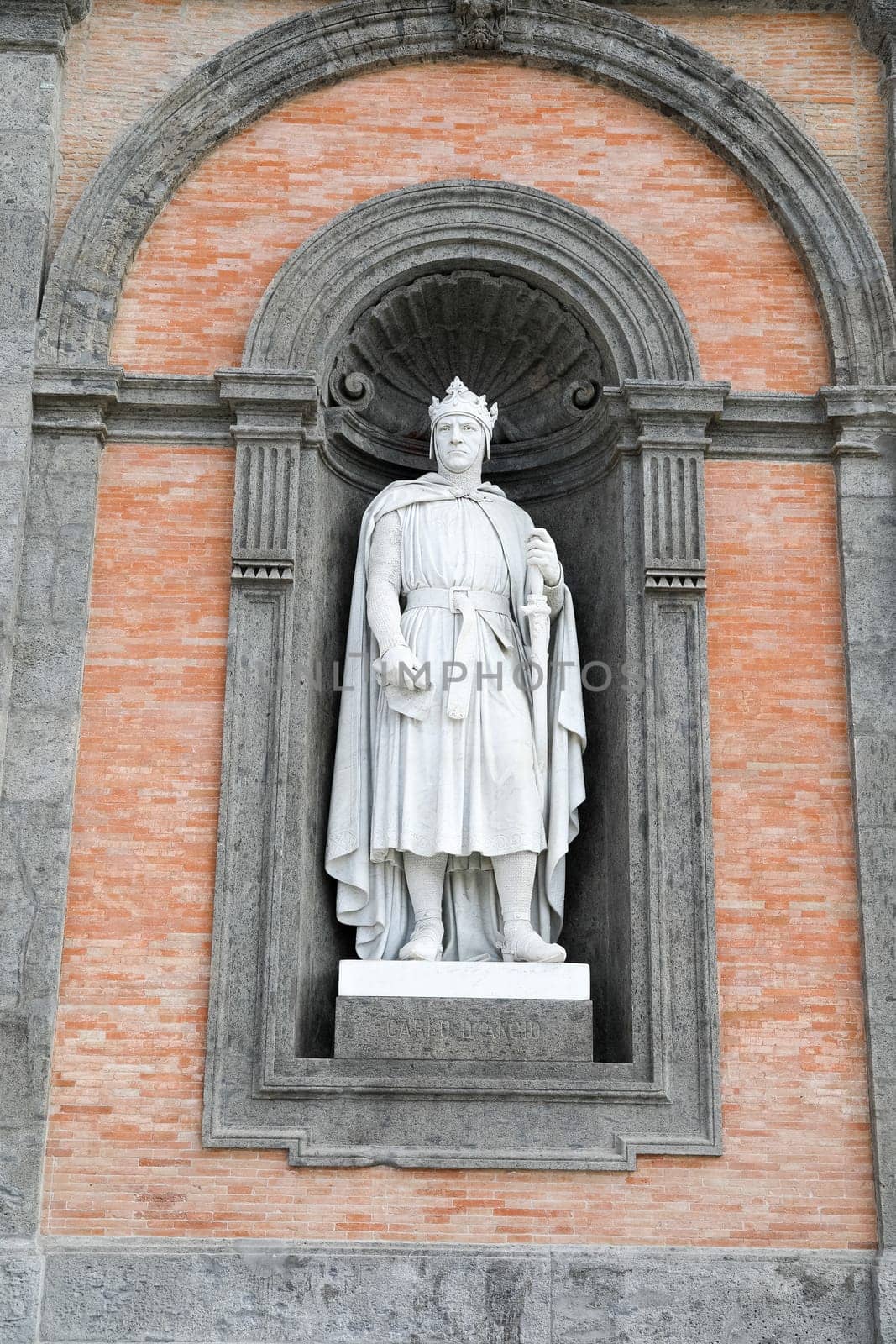 Alfonso D'Aragona statue on facade of the Palazzo Reale. Napoli, Italy