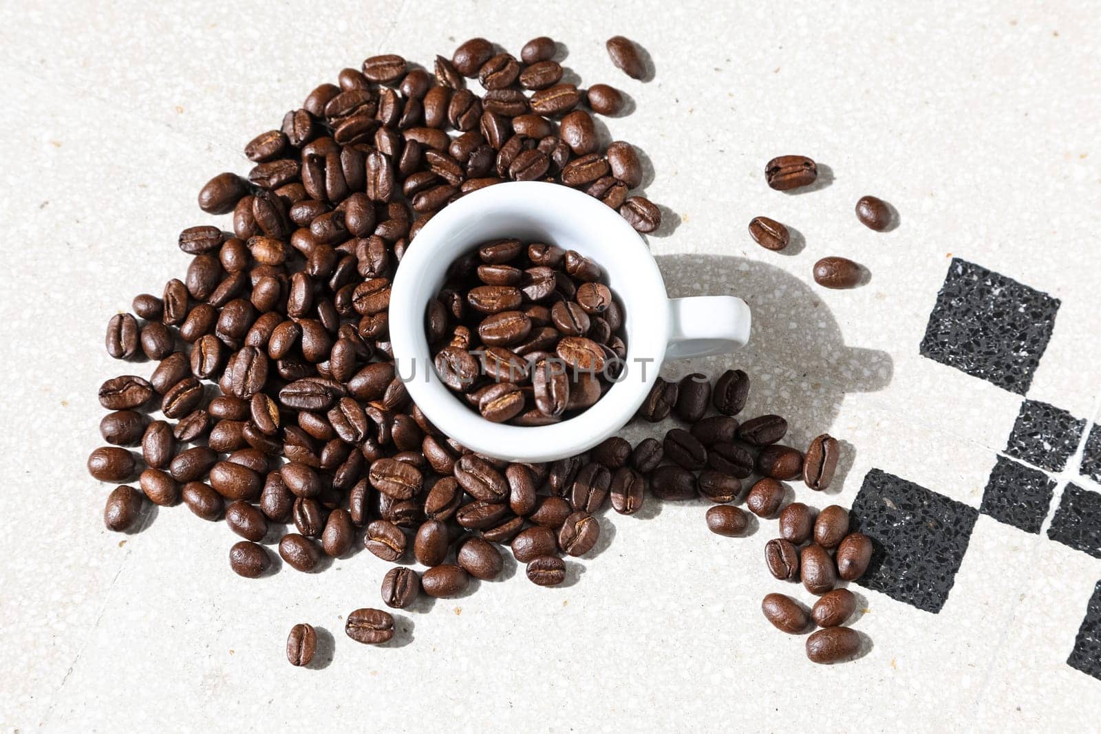 Close up of a cup of black coffee grains ad a cup