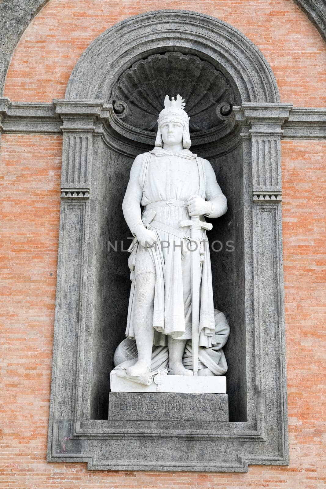 Federico II di Svevia statue on facade of the Palazzo Reale. Napoli, Italy