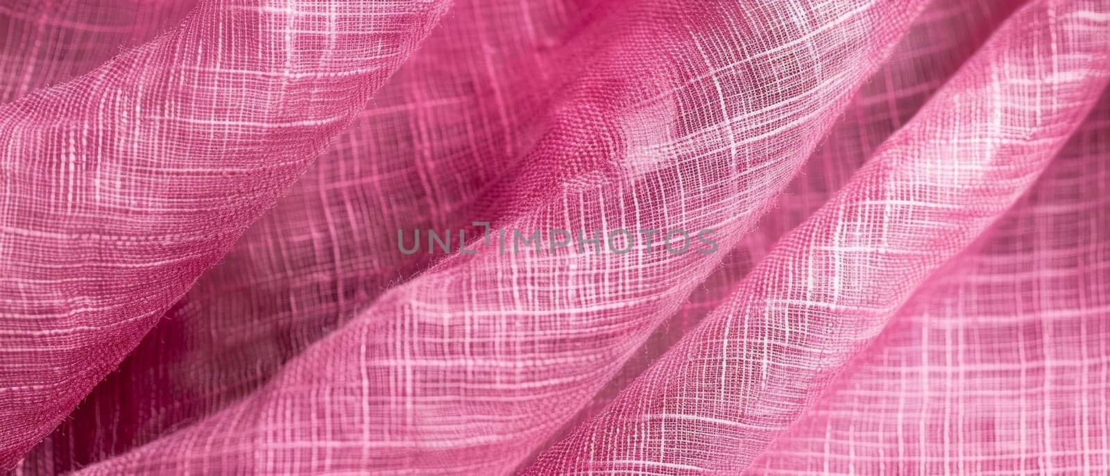 A vibrant pink textile with a distinctive texture, the folds catching the light to enhance the color's intensity