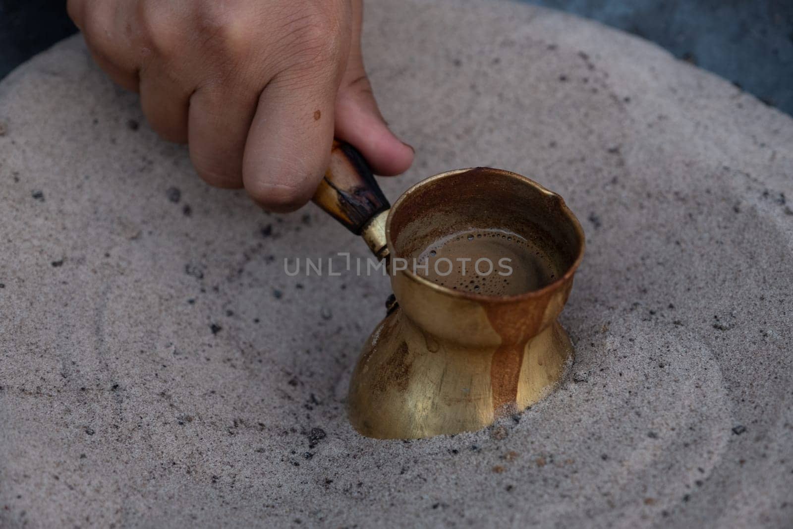 Preparation of desert arabic coffee on hot sand