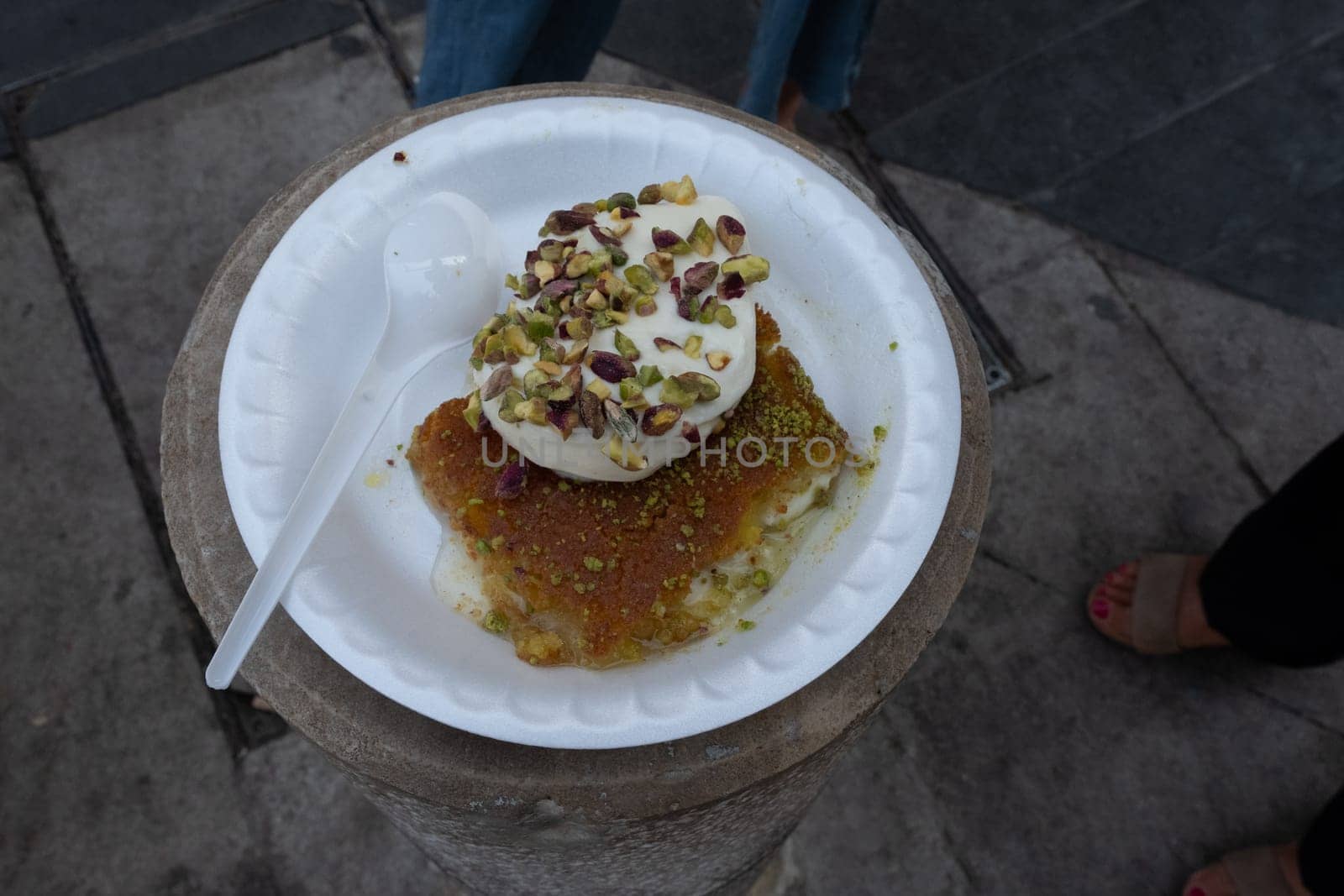 Arabic dessert Kunafa made with cheese and honey and pistache with ice cream