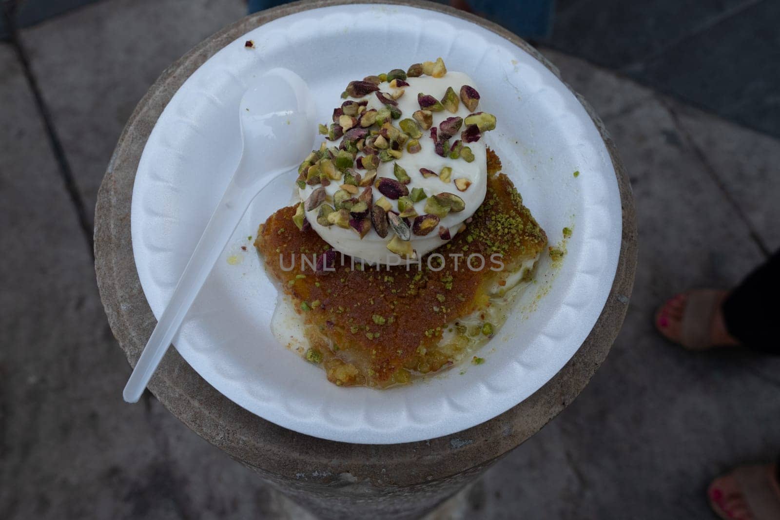 Arabic dessert Kunafa made with cheese and honey and pistache with ice cream